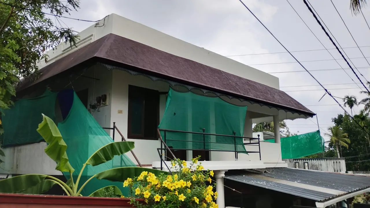 Exterior of the Ashraf Gents Hostel building on NAD Road, Kalamassery