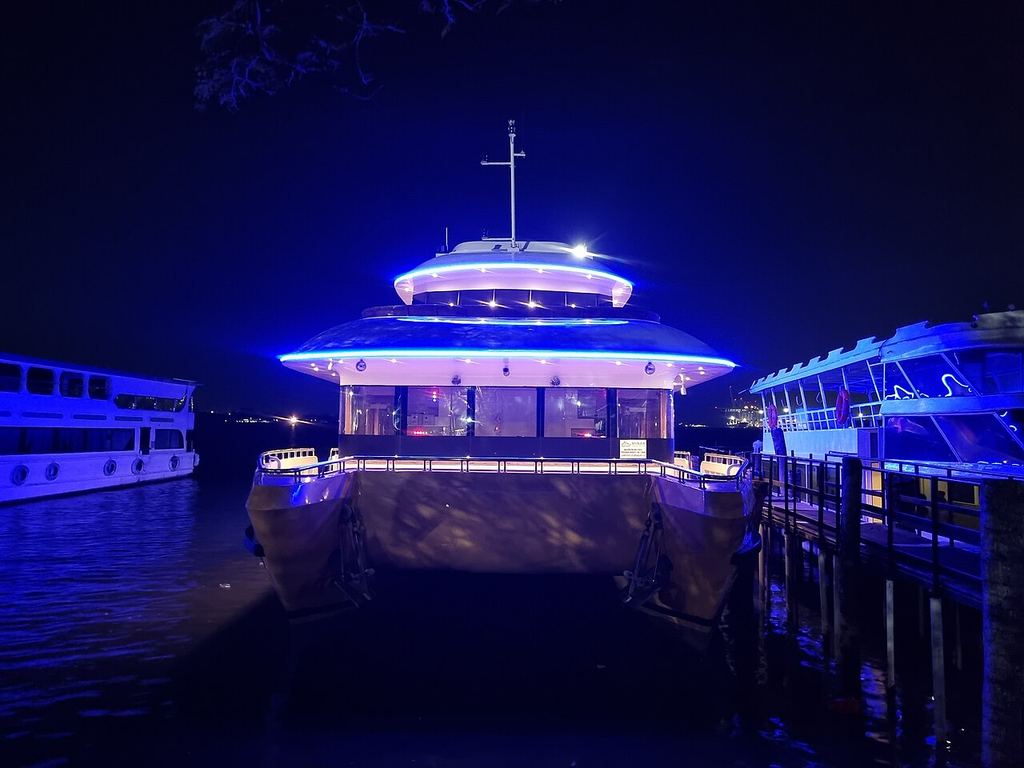 Boats lit up at night at Marine Drive, Kochi
